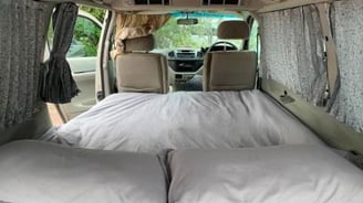 a couple of beds in a explore africa camper