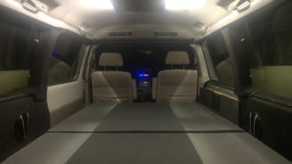 a camper van with bed and halo lighting