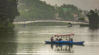tourist boating in Sumendu lake while enjoying the view of Indreni Pool