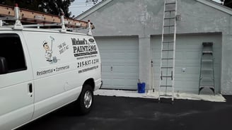a van parked in front of a garage door