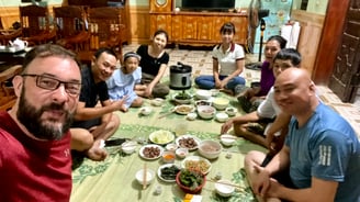 a group of people sitting around a table with food