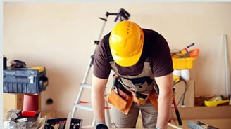 Tra workers renovating interior walls and ceilings in a commercial building