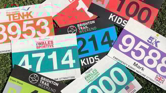 a photo of a stack of colorful race bibs