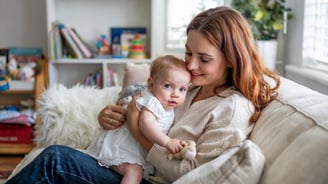 a woman holding a baby in her arms