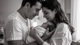 a man and woman holding a baby in a room