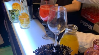 a bartender is pouring a drink at a bar