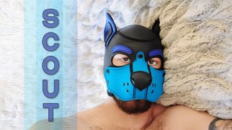 A man in a pup mask, with a name plate: SCOUT