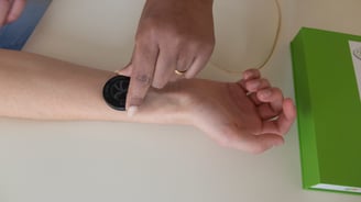 a person holding a redater on an arm