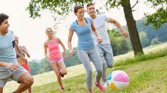 a group of people playing soccer in a field