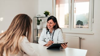 a woman being treated by a doctor in a white coat