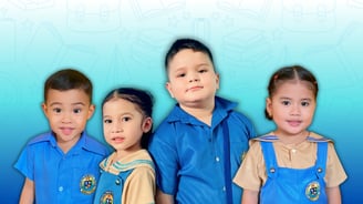 Shelomith pre-elementary students smiling in uniform with school-themed light blue background.