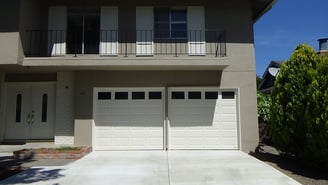 2 short panel garage doors with glass.