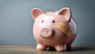 piggy bank with a bandaid for inflation affecting retirement