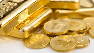 high quality gold bars and coins on a white surface