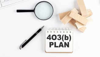 magnifying glass a pen and blocks for 403b plans