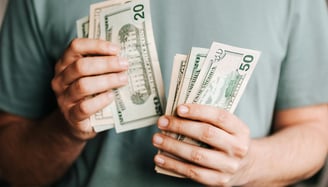 cash in someones hand for potential fees