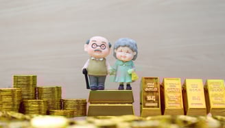 elderly couple with gold bars and coins for retirement