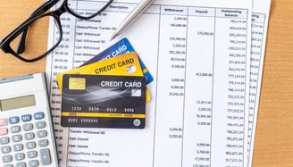 glasses a calculator and credit card for managing credit