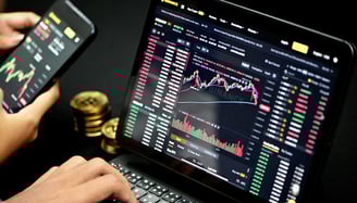 person trading on their computer with bitcoin on the side