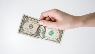 a dollar bill being held for dollar cost averaging