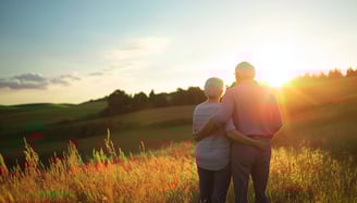 elderly couple watching the scenery and sunset with long term care insurance