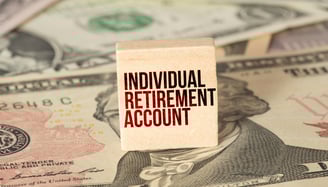 individual retirement account label on a block with money in the background