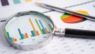 magnifying glass looking at statistics and values