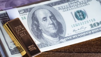 gold bar on a 100 dollar bill