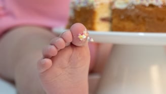 a baby's feet and feet on a cake