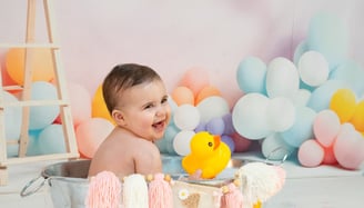 a baby in a tubtub with a rubber duck in it