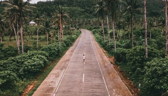 a person riding a bike down a road