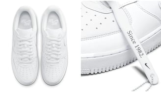a pair of white sneakers with a shoelacee on the side