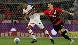 two men playing soccer on a field