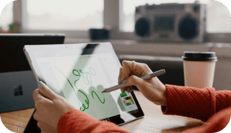 a person holding a pen and writing on a tablet
