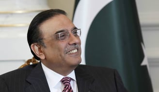 Asif Ali Zardari in a suit and tie smiling