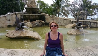 Lady rests by a fountain in La Romana, Dominican Republic