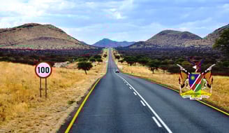 a road sign on a country road with a sign that says 100