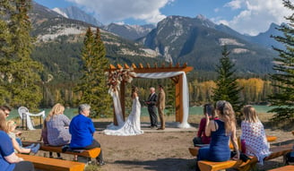 Couple having a elopement ceremony at the base of a mountain In banff