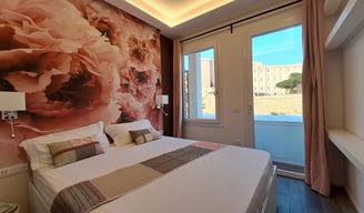 a bedroom with a large bed and a television for vacation with view of Cagliari
