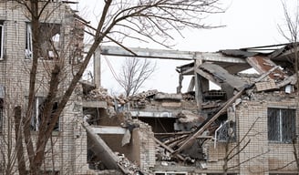 The image shows the remains of a severely damaged building