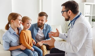 a doctor talking to a child in a living room martin pe / coach