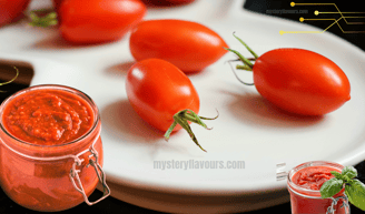 Freshly made delicious and simple homemade tomato sauce, in a jar, with fresh tomatoes