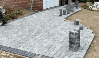 Driveway block paving in progress with concrete sub-base in Bristol