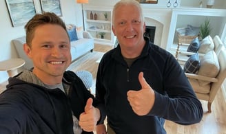 Happy customer posing with Alex, Vision Flooring. On the background there is part of the work we did