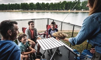 a family eating cookies on an RV deck