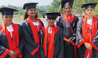 a group of women in graduation gowns 