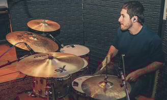 a man recording drums for an artist