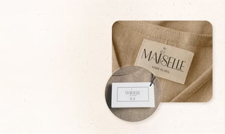 Branded woven label and hangtag design for apparel. By UrBrand Studio.