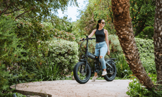 a woman riding a bike on a path