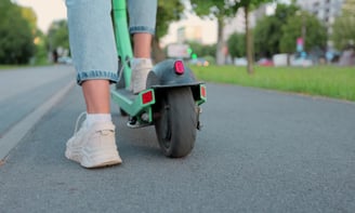a person riding a scooter on a street